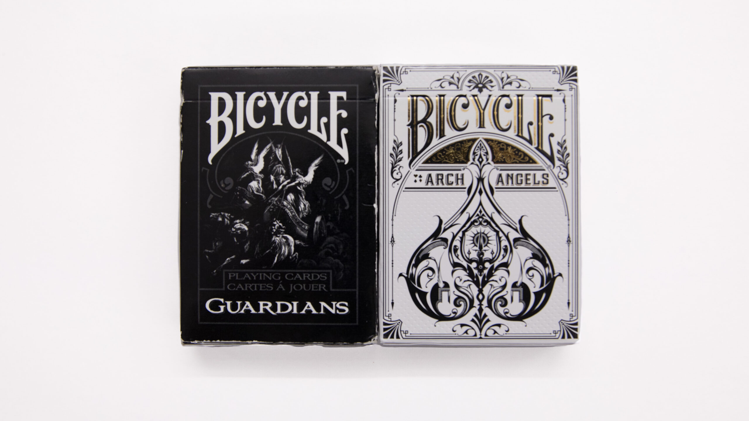 2 adjacent decks of Bicycle playing cards. a black one marked 