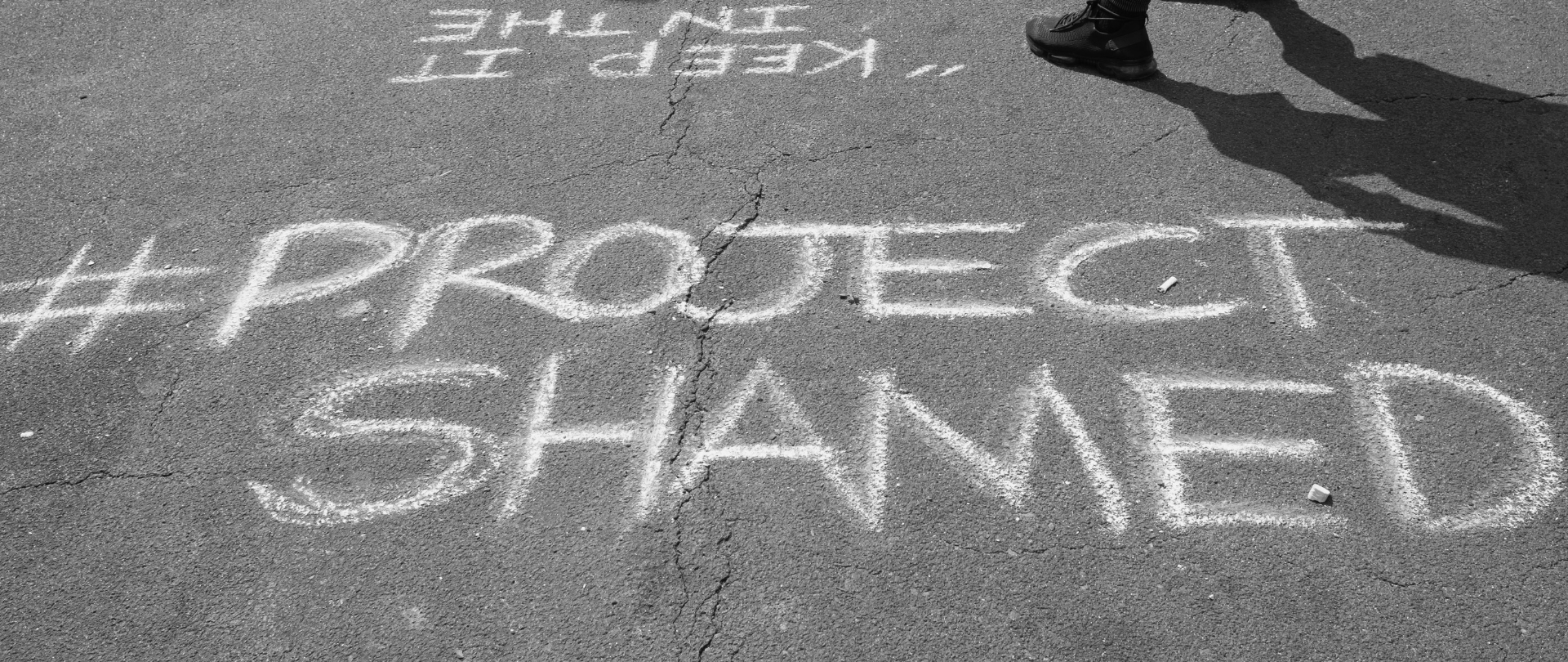 Project Shamed hashtag written on the sidewalk in chalk.