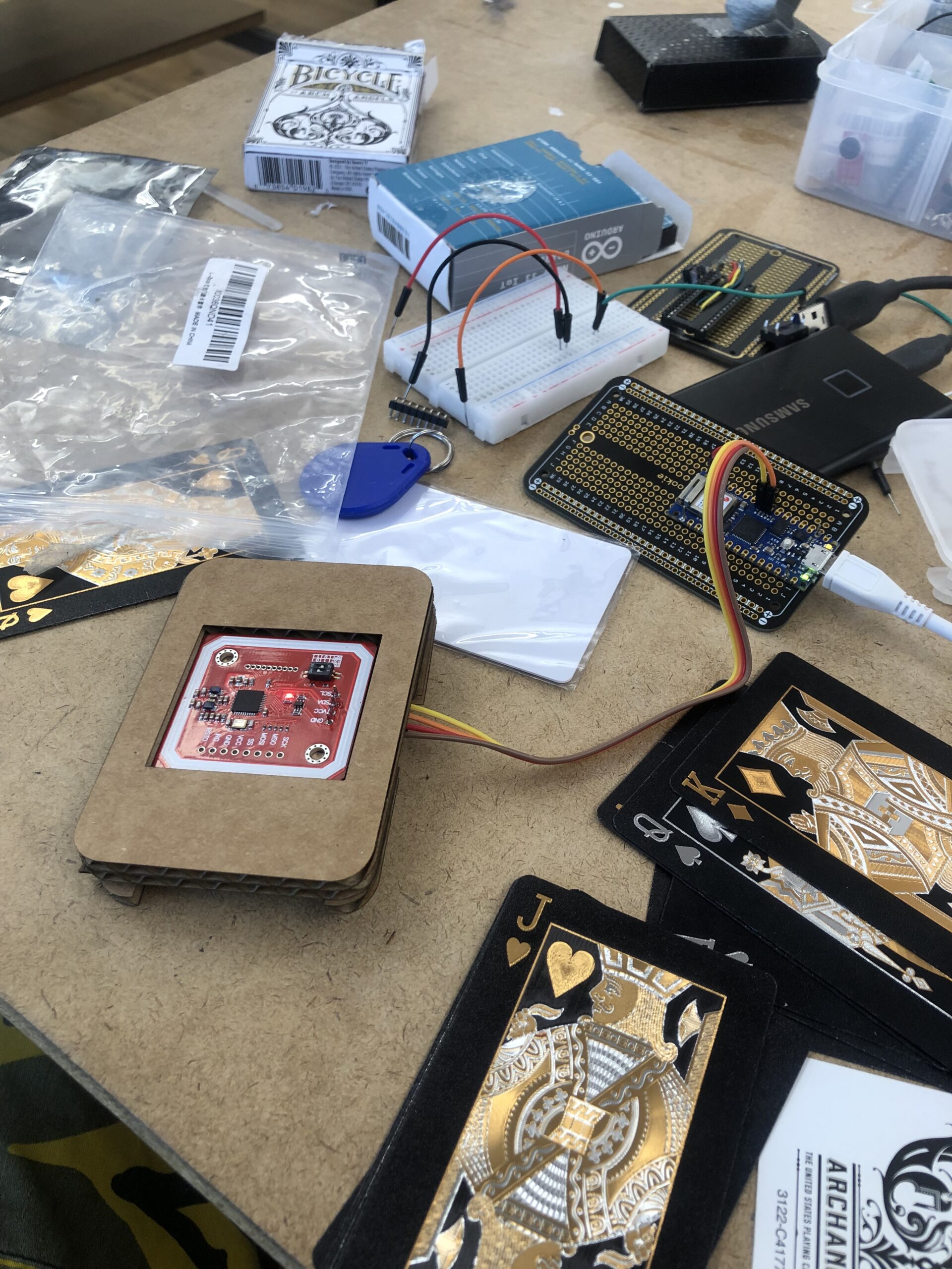 Messy desk while testing the card readers connection to the arduino. The rea=der is contained within the updated cardboard prototype