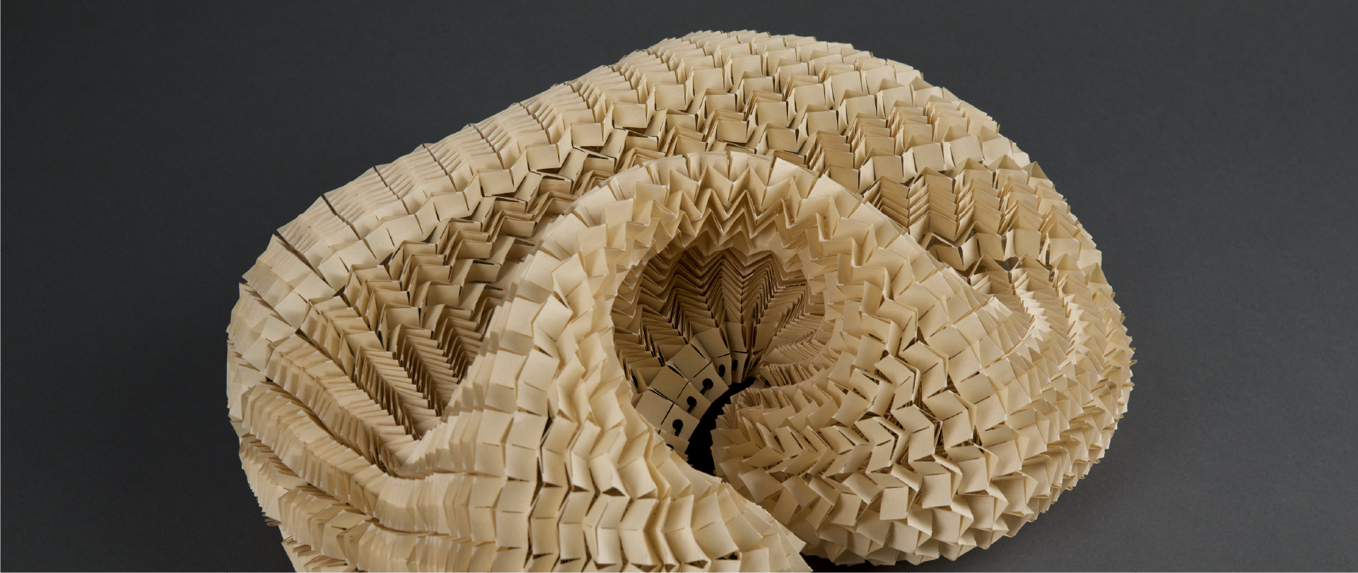 A paper sculpture made out of a paper mesh created from a method called kirigami.