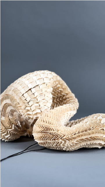 A paper sculpture made out of a paper mesh created from a method called kirigami.