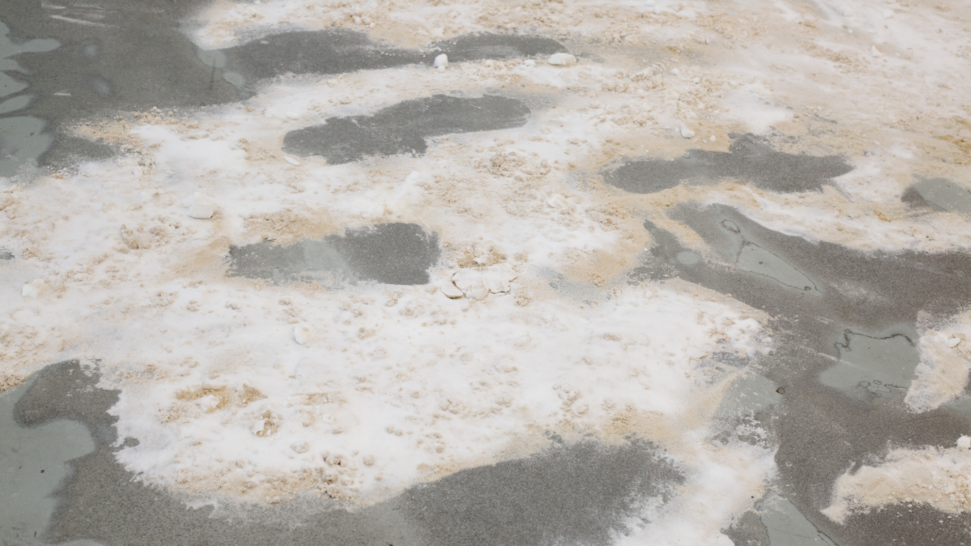 salt mixed with sand in organic shapes on a concrete floor
