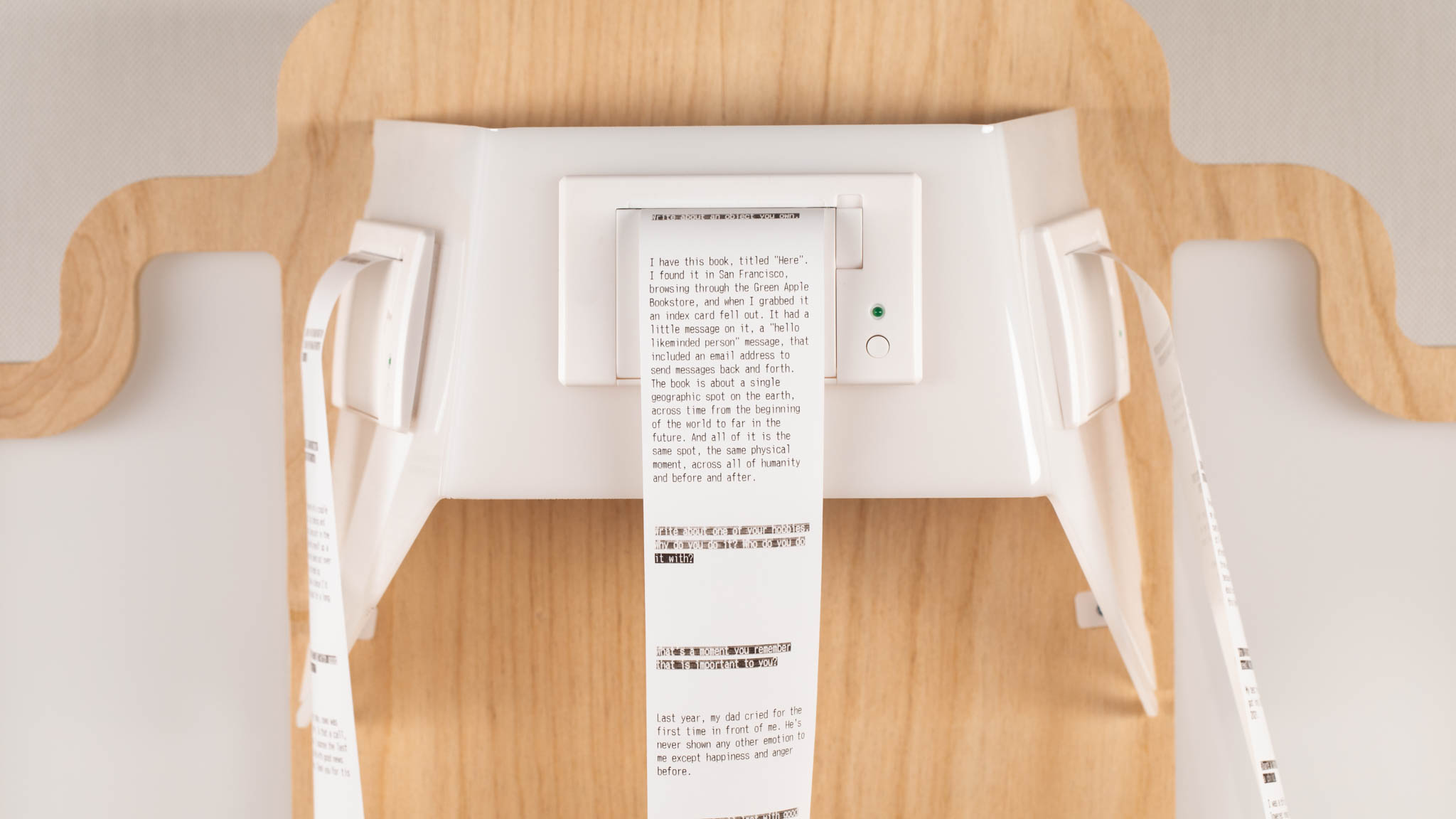 Thermal printer mounted to backboard, printing text onto paper.