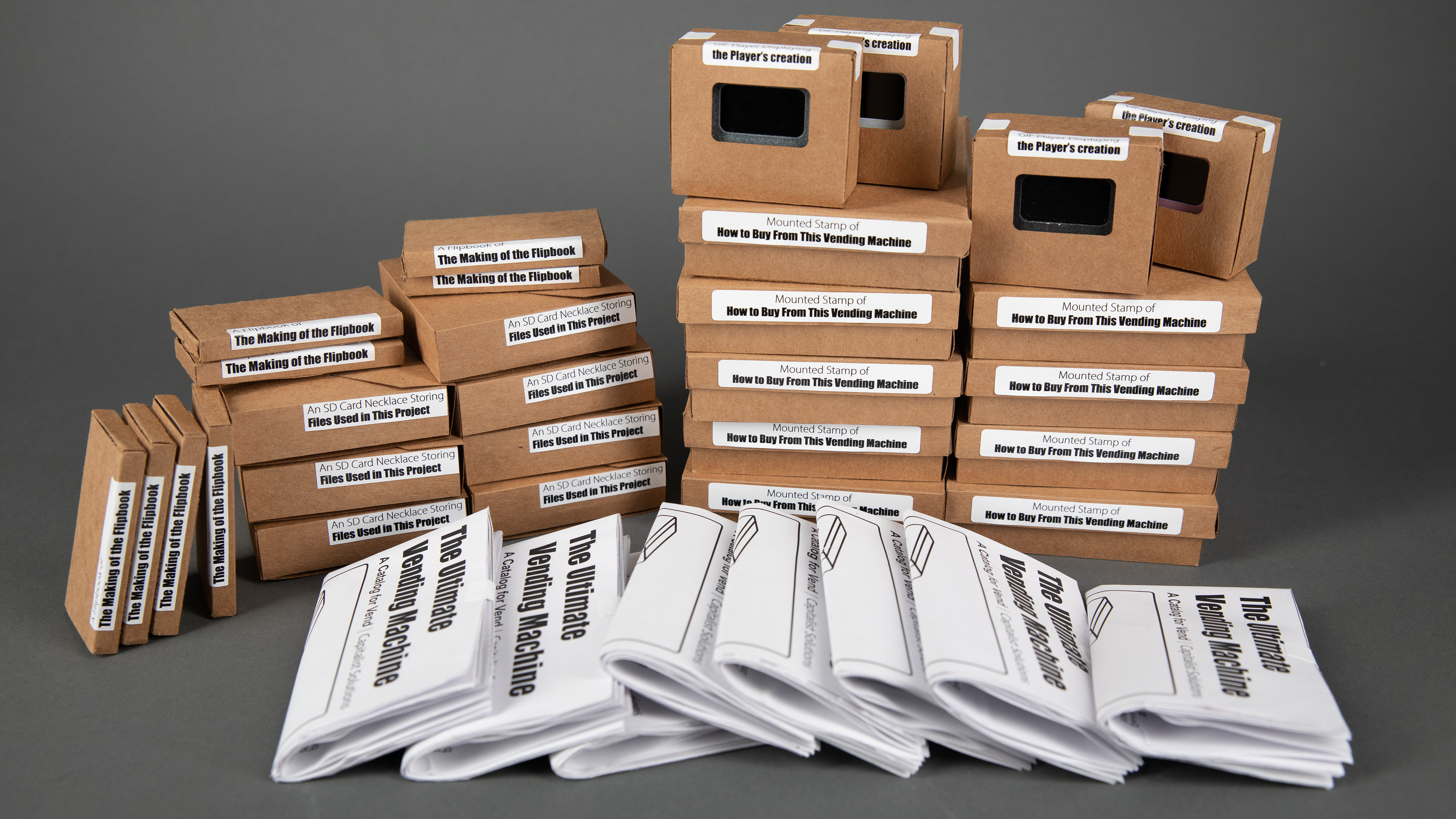 The Catalog Volume One on display in the row of the Ultimate Vending Machine. The Catalog are folded and organized for the display.